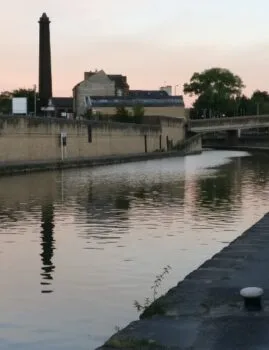 Mill chimney and its reflection in canal