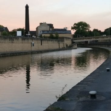 Mill chimney and its reflection in canal