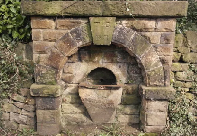 Old drinking fountain on Spa Lane with inscription "TC 1871"